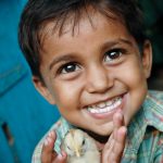 Young boy with chick Project name: ADP Miraj Asia digital color vertical