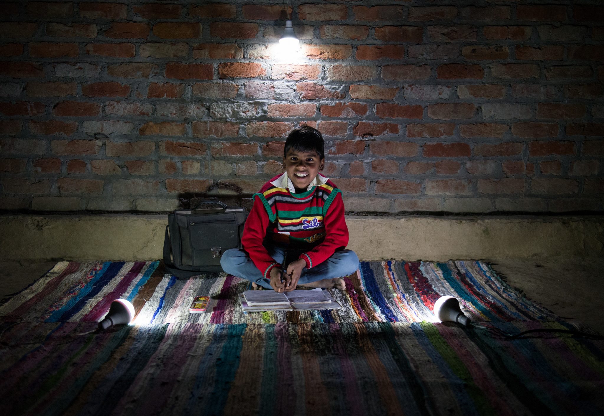 Eight-year-old Alam studying with the help of the solar lights. "We had to take turns to study as the light from our kerosene-powered lamps was insufficient for us five siblings. The dim light caused eye irritation due to smoke emitted and was straining to the eye. Studying for examinations was the most challenging part," says Farzana, Alam's sister. "We go to our friend's house to play carrom, snake and ladder games in the night. Since the solar bulbs are very luminous, all my siblings can study together and my grades have improved," he says. Alam aspires to become a school teacher so that he can brighten up the lives of the less fortunate in his community. Summary: Solar bulbs provided by World Vision have provided a new way of life to more than 400 families in Sambhal, Uttar Pradesh, India. Daily activities have extended into the evenings by about six hours and families such as Farzana's are experiencing much more productivity. Project/ADP Name: Moradabad ADP