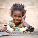 Girl with chicks. Nafi Balde (age 4), Yiri Koye Village. Photo selects provided by World Vision Canada. Project name: Kounkane Adp Africa digital color horizontal