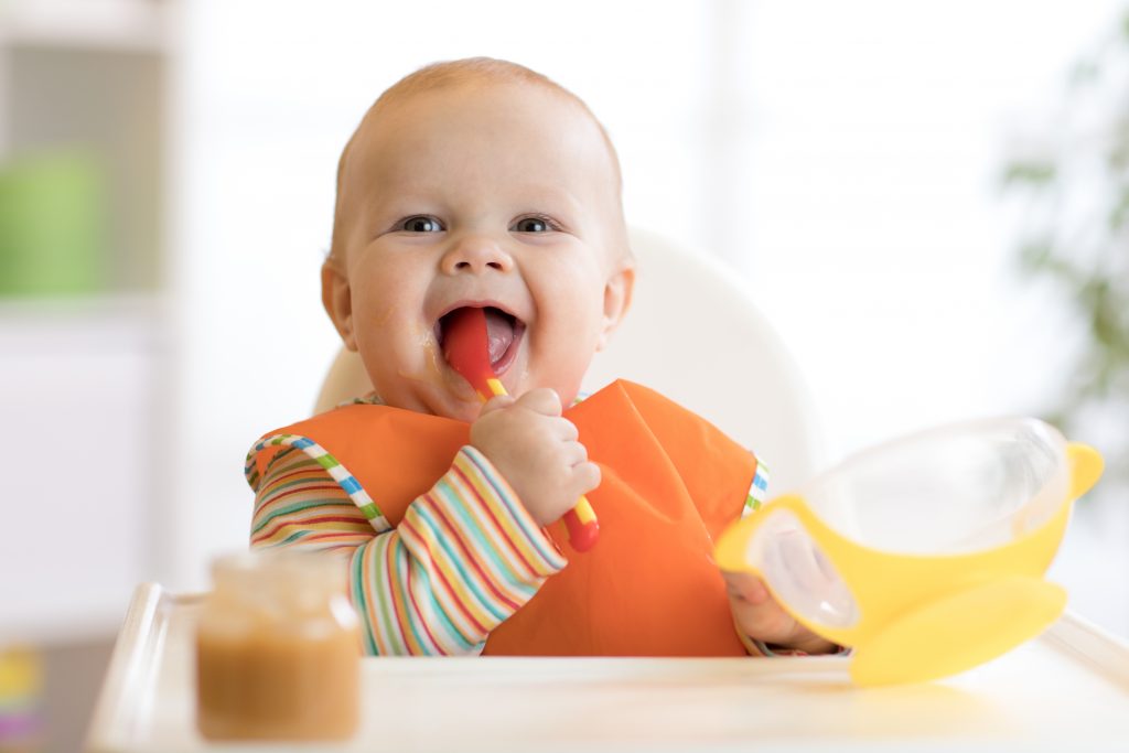 Happy,Infant,Baby,Boy,Spoon,Eats,Itself,At,Home