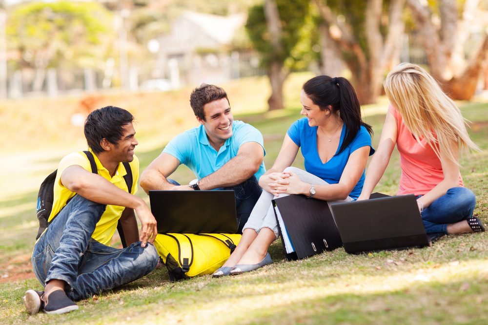Group,Of,Cheerful,University,Students,Relaxing,Outdoors,On,Campus