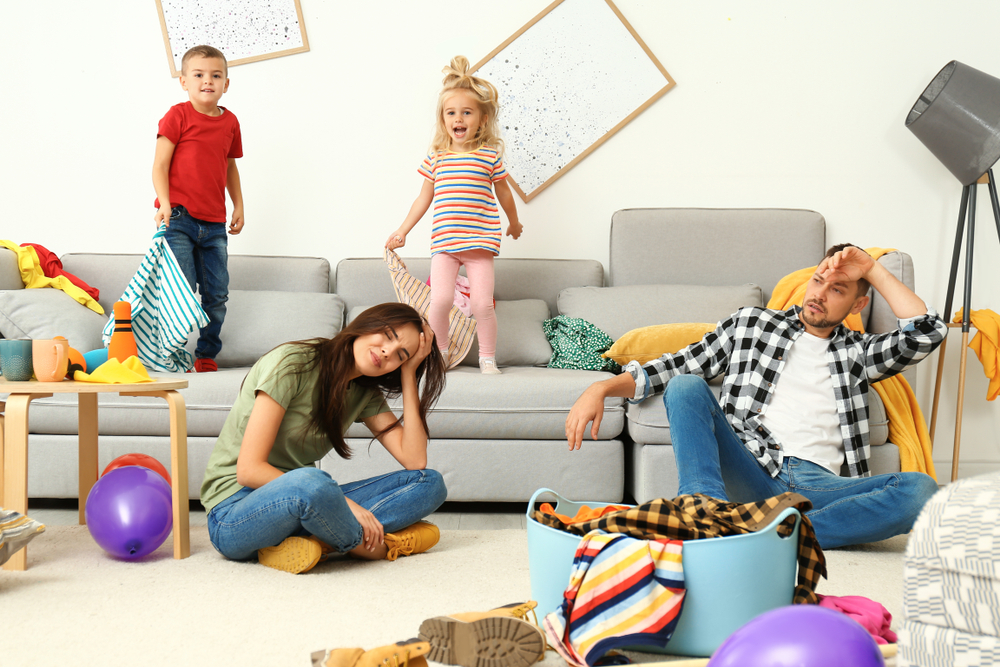 Frustrated,Parents,And,Their,Mischievous,Children,In,Messy,Room