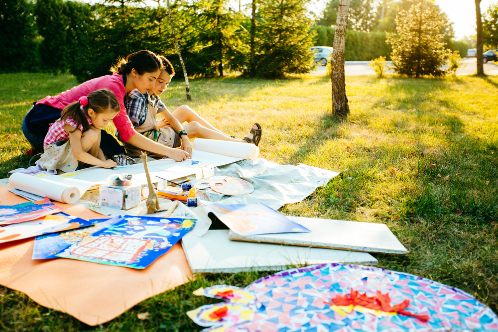 Happy,Mother,,And,Two,Kids,Are,Painting,In,The,Park.