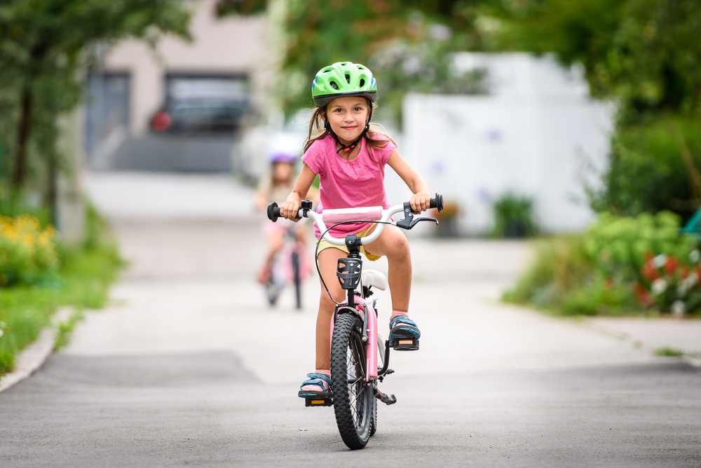 Children,Learning,To,Drive,A,Bicycle,On,A,Driveway,Outside.