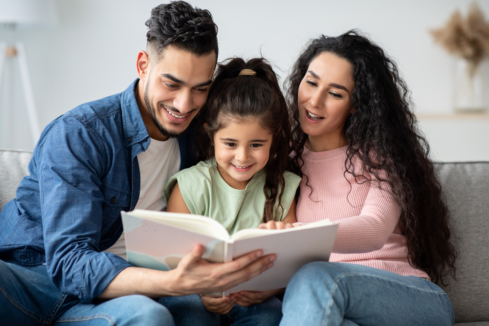 Young,Arabic,Parents,Reading,Book,With,Their,Cute,Little,Daughter