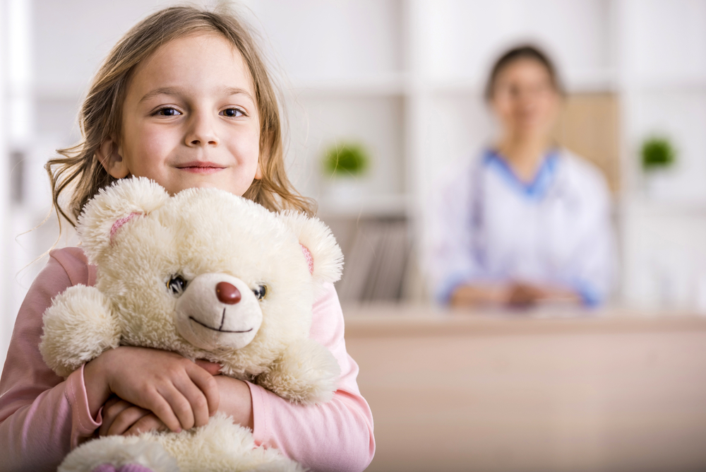 Little,Girl,With,Teddy,Bear,Is,Looking,At,The,Camera.