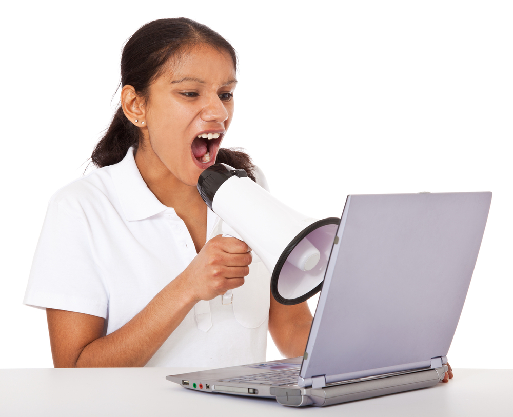 Indian,Woman,Using,Megaphone,Screaming,At,Laptop