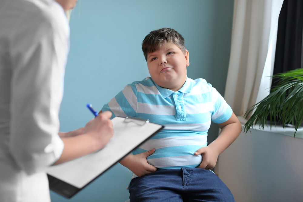 Overweight,Boy,Consulting,With,Doctor,In,Office