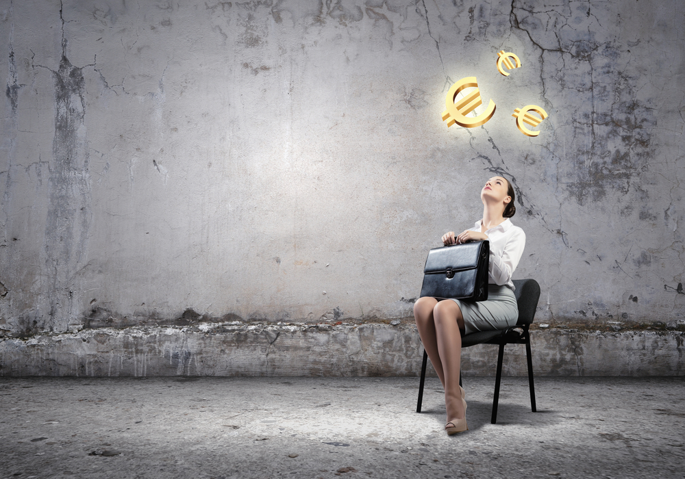 Image,Of,Businesswoman,Sitting,On,Chair,With,Suitcase,In,Hands