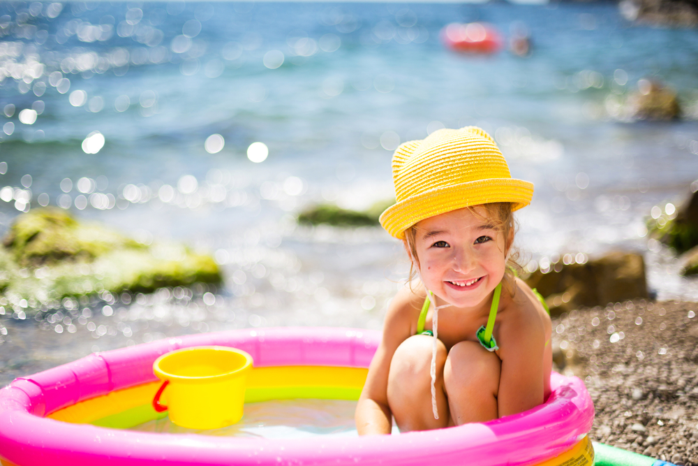 Girl,In,Yellow,Straw,Hat,Plays,In,Outdoor,Near,Sea,