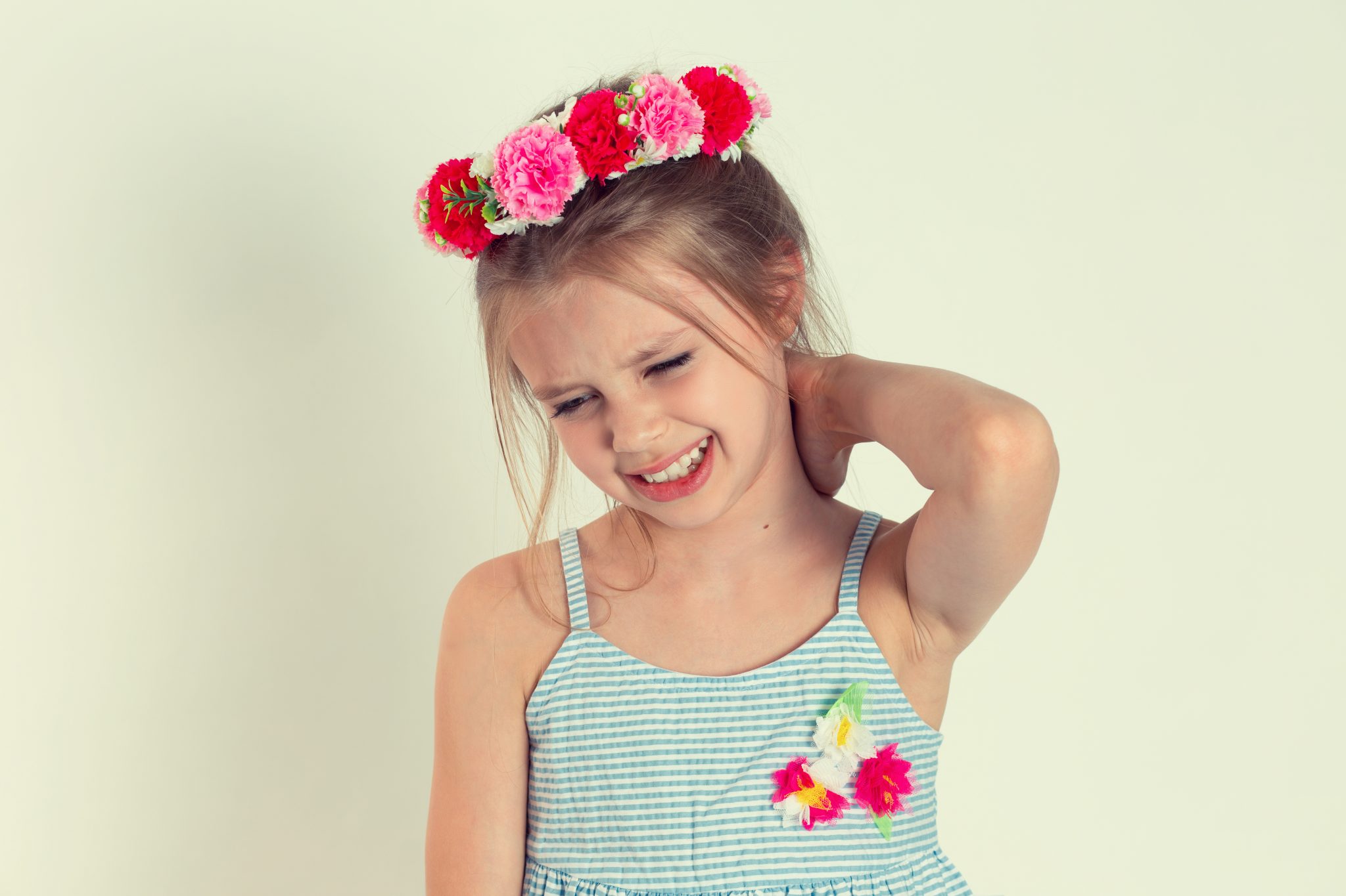 Neck pain. Portrait stressed unhappy young teenager girl woman with back pain, after long school hours studying isolated white yellow wall background. Negative human emotions facial expression feeling