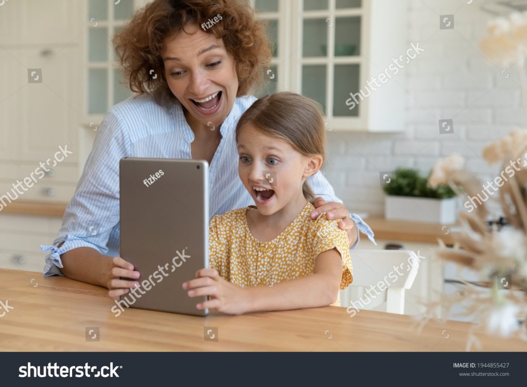 stock-photo-stunned-happy-young-caucasian-mother-and-little-s-daughter-look-at-tablet-screen-shocked-by-online-1944855427