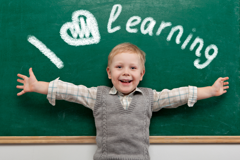 Cheerful,Smiling,Child,At,The,Blackboard.,School,Concept