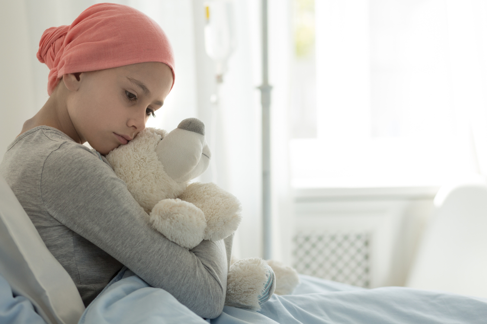 Weak,Girl,With,Cancer,Wearing,Pink,Headscarf,And,Hugging,Teddy