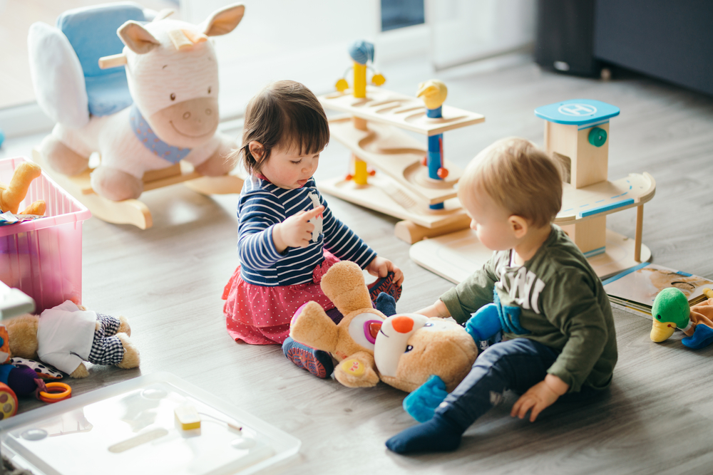Cute,Little,Girl,And,Boy,Playing,With,Toys,By,The