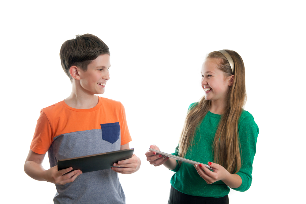 Two,Pupils,With,Tablet,Pc,Is,Looking,At,Each,Other