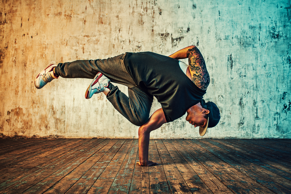 Young,Man,Break,Dancing,On,Wall,Background.,Vibrant,Colors,Effect.