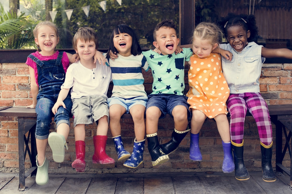 Group,Of,Kindergarten,Kids,Friends,Arm,Around,Sitting,And,Smiling