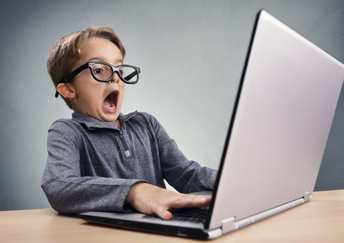 Shocked,And,Surprised,Boy,On,The,Internet,With,Laptop,Computer