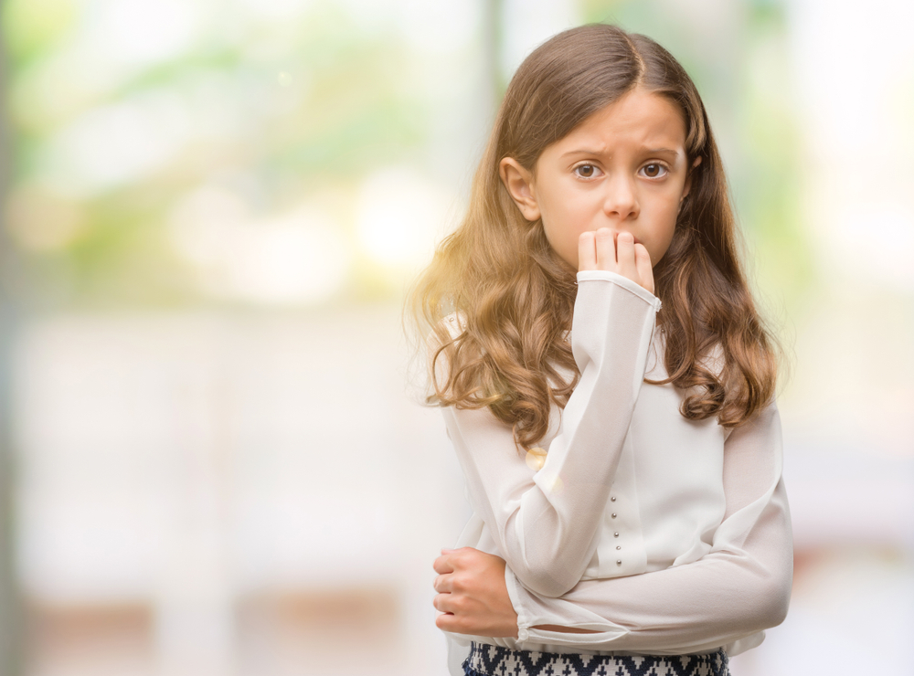 Brunette,Hispanic,Girl,Looking,Stressed,And,Nervous,With,Hands,On