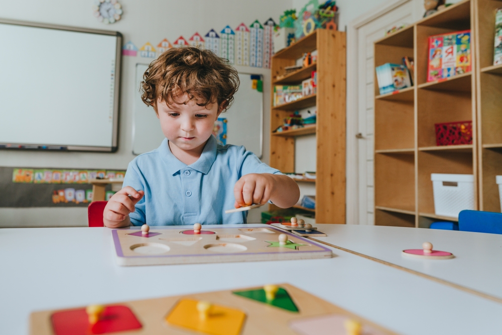 Boy,Playing,With,Educational,Wooden,Toys,And,Sort,Geometric,Shapes